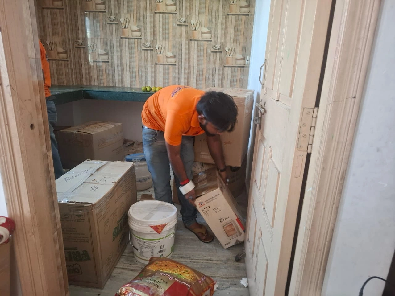 Worker packing household items during a home shift in Patna by Mehar Packers and Movers.