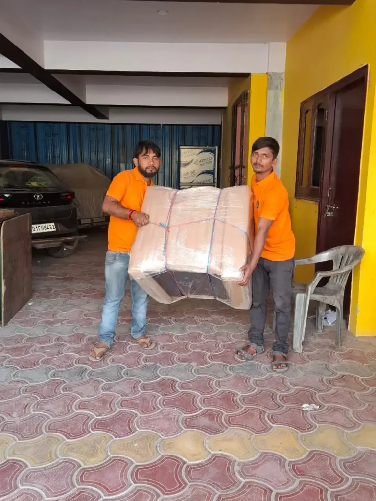 Professional cargo couriers from Mehar Packers and Movers handling a securely packed shipment in Patna.