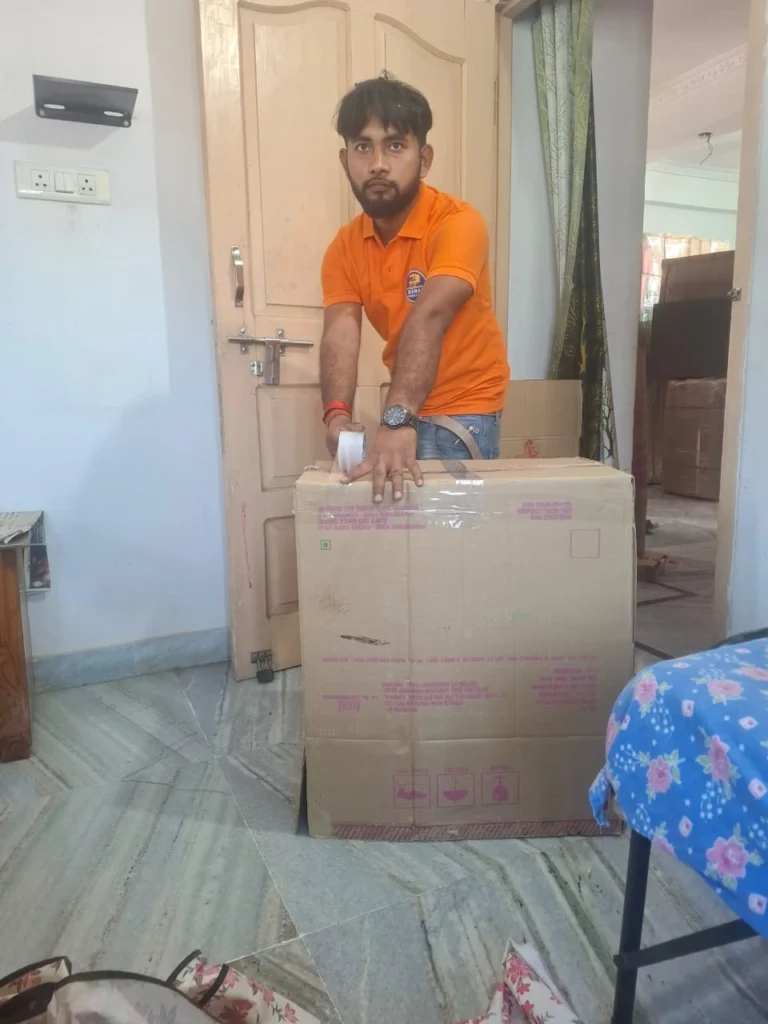 Mehar Packers and Movers team member taping a box during household shifting in Patna.