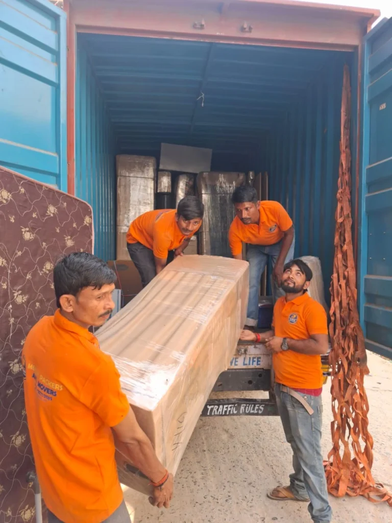 Mehar Packers and Movers team loading wrapped furniture into a truck during a home shifting service in Patna.