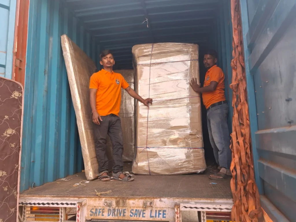 Mehar Packers and Movers team loading goods into a container truck for safe delivery across Patna.