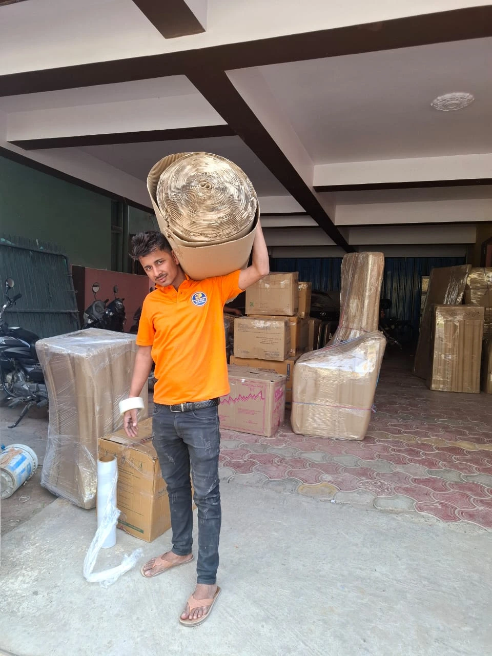 Mehar Packers and Movers worker carrying packing material for household shifting in Patna.