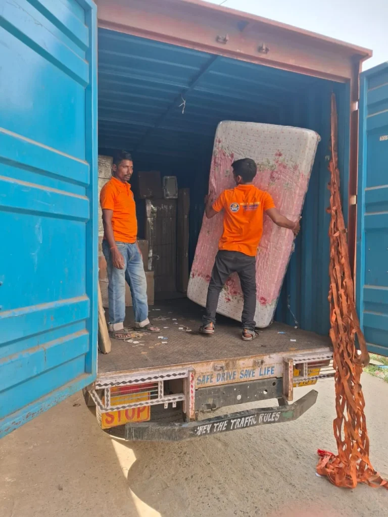 Workers from Mehar Packers and Movers loading a mattress into a moving truck in Patna.