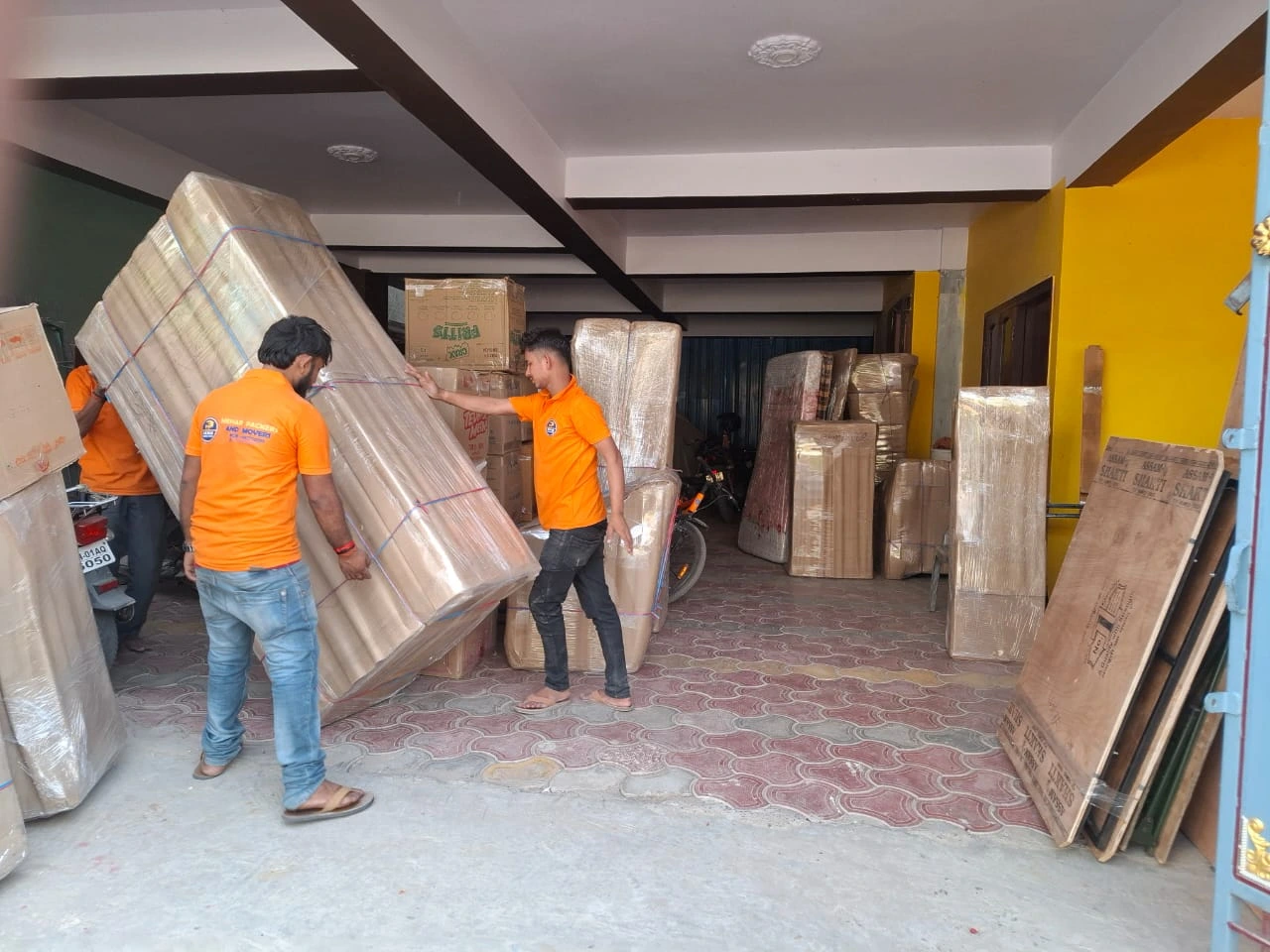 Mehar Packers and Movers team carefully shifting large packed furniture during a home shifting service in Patna.