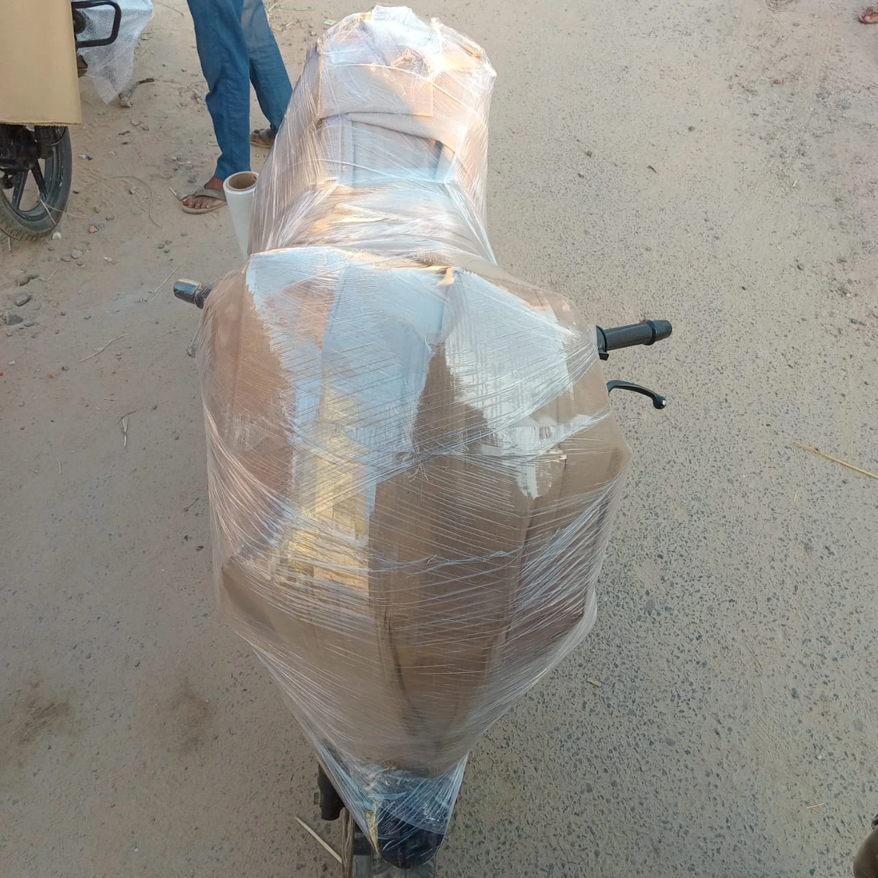Bike fully wrapped in cardboard and plastic by Mehar Packers and Movers for secure transportation during home shifting service in Patna.