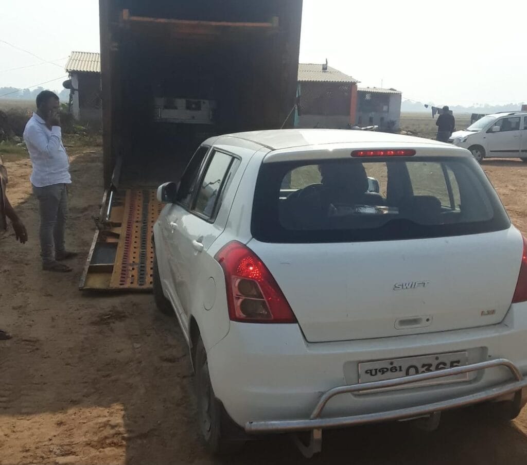 White Swift car being loaded into a vehicle carrier for Car Shifting in Patna by Mehar Packers and Movers.